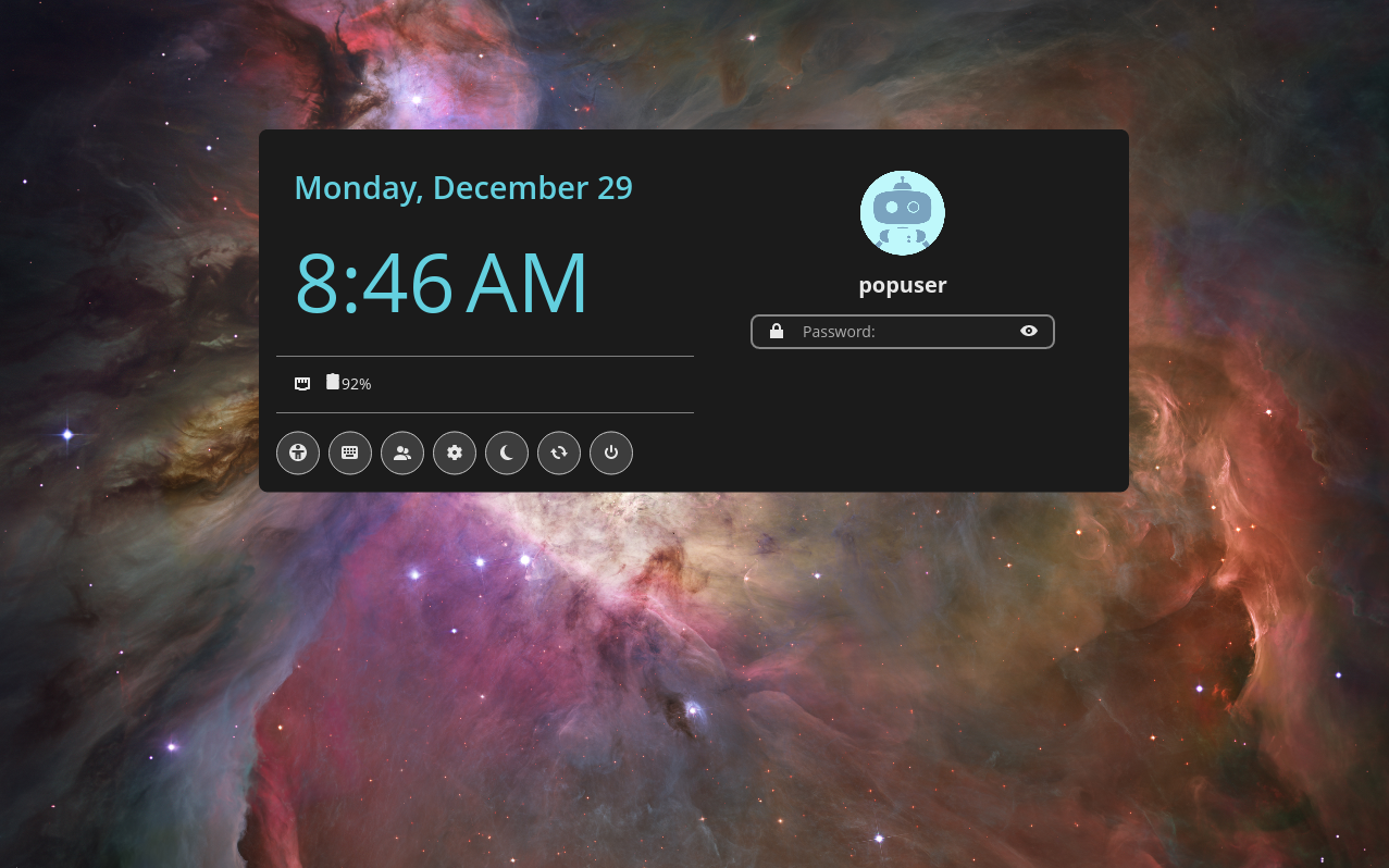 COSMIC Greeter screen with date and time, clickable settings icons underneath and a password prompt box to the right. Icons under the date and time from left to right include; accessibility, keyboard layout, user accounts, session settings, suspend, restart and shutdown.