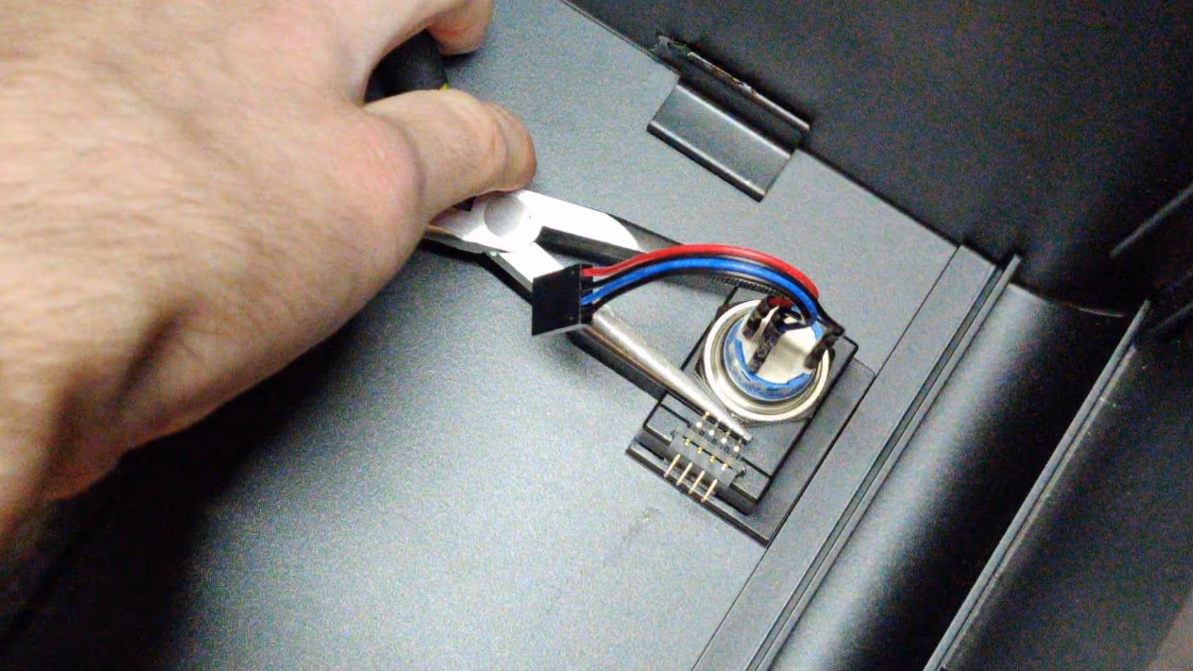 Tightening the nut with needle-nose pliers