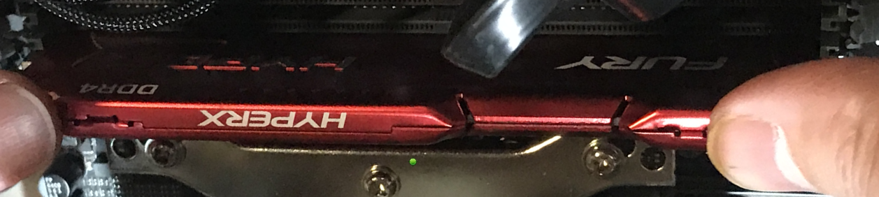 Pressing the RAM stick down into place